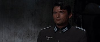 Movie still from “The Guns of Navarone” (1961), directed by J. Lee Thompson – A person wearing a uniform; Close Up shot, Over the shoulder angle