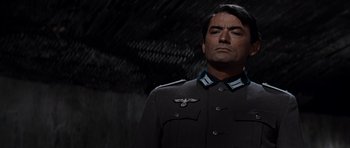 Movie still from “The Guns of Navarone” (1961), directed by J. Lee Thompson – A man in a military uniform is looking up; Close Up shot, Low angle