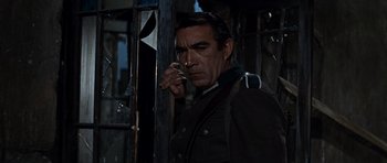 Movie still from “The Guns of Navarone” (1961), directed by J. Lee Thompson – A man in a military uniform talking on a cell phone; Close Up shot, Low angle