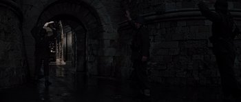 Movie still from “The Guns of Navarone” (1961), directed by J. Lee Thompson – A man walking in the dark near a stone wall; Wide shot, High angle