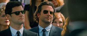 Movie still from “The Hangover Part III” (2013), directed by Todd Phillips – A person wearing a suit and sunglasses; Close Up shot, Over the shoulder angle