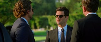 Movie still from “The Hangover Part III” (2013), directed by Todd Phillips – A man in a suit and sunglasses talking to another man; Close Up shot, Over the shoulder angle
