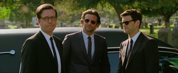 Movie still from “The Hangover Part III” (2013), directed by Todd Phillips – A group of men standing next to each other in front of a car; Medium shot, Over the shoulder angle
