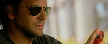 Movie still from “The Hangover Part III” (2013), directed by Todd Phillips – A person wearing a pair of sunglasses; Close Up shot, Over the shoulder angle