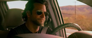 Movie still from “The Hangover Part III” (2013), directed by Todd Phillips – A person in a car wearing sunglasses; Close Up shot, Low angle