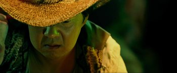 Movie still from “The Hangover Part III” (2013), directed by Todd Phillips – A person wearing a straw hat and a yellow shirt; Close Up shot, Low angle