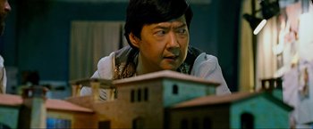 Movie still from “The Hangover Part III” (2013), directed by Todd Phillips – An asian man looking at a model of a building; Close Up shot, Over the shoulder angle