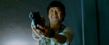 Movie still from “The Hangover Part III” (2013), directed by Todd Phillips – A man holding a gun in his hands; Close Up shot, Low angle