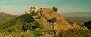 Movie still from “The Hangover Part III” (2013), directed by Todd Phillips – A road going down a hill with a house on top of the hill; Extreme Wide shot, High angle