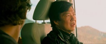 Movie still from “The Hangover Part III” (2013), directed by Todd Phillips – A man sitting in the back seat of a car; Close Up shot, Over the shoulder angle