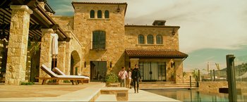 Movie still from “The Hangover Part III” (2013), directed by Todd Phillips – Two people walking in front of a large stone building; Wide shot, Low angle