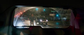 Movie still from “The Hangover Part III” (2013), directed by Todd Phillips – A man standing in front of a car on a city street at night; Wide shot, Over the shoulder angle