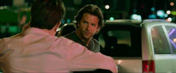 Movie still from “The Hangover Part III” (2013), directed by Todd Phillips – A man with long hair is looking at another man in a car; Close Up shot, Over the shoulder angle