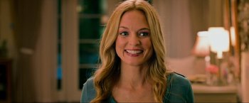 Movie still from “The Hangover Part III” (2013), directed by Todd Phillips – A woman with long blonde hair smiling for the camera; Close Up shot, Over the shoulder angle