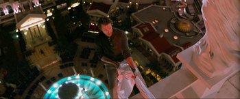 Movie still from “The Hangover Part III” (2013), directed by Todd Phillips – A man holding a bag while standing in a building; Wide shot, Overhead angle