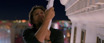 Movie still from “The Hangover Part III” (2013), directed by Todd Phillips – A man holding a white cloth up to his face; Close Up shot, Low angle