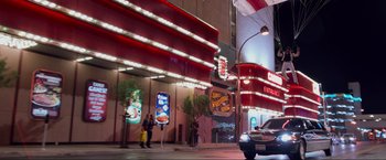 Movie still from “The Hangover Part III” (2013), directed by Todd Phillips – People walking on the sidewalk in front of a restaurant; Extreme Wide shot, Low angle