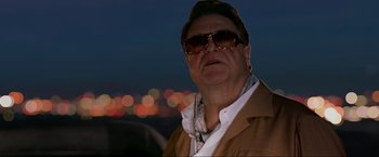 Movie still from “The Hangover Part III” (2013), directed by Todd Phillips – A person wearing sunglasses and a jacket; Close Up shot, Low angle