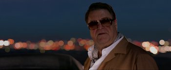 Movie still from “The Hangover Part III” (2013), directed by Todd Phillips – A person wearing sunglasses and a jacket; Close Up shot, Low angle