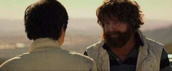 Movie still from “The Hangover Part III” (2013), directed by Todd Phillips – A man with a beard is talking to a woman; Close Up shot, Over the shoulder angle