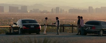 Movie still from “The Hangover Part III” (2013), directed by Todd Phillips – Two people standing next to each other near a car; Wide shot, Over the shoulder angle
