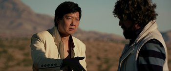 Movie still from “The Hangover Part III” (2013), directed by Todd Phillips – A man wearing a white shirt talking to another man; Medium shot, Over the shoulder angle