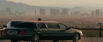 Movie still from “The Hangover Part III” (2013), directed by Todd Phillips – A man sitting in the back of a black limo; Extreme Wide shot, Over the shoulder angle