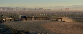 Movie still from “The Hangover Part III” (2013), directed by Todd Phillips – A man standing on top of a hill next to a car; Extreme Wide shot, Low angle