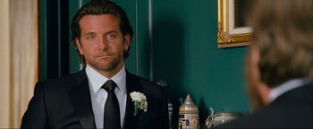 Movie still from “The Hangover Part III” (2013), directed by Todd Phillips – A man in a suit and tie with a flower in his lapel; Close Up shot, Over the shoulder angle