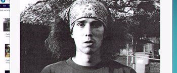 Movie still from “The Hatchet Wielding Hitchhiker” (2023), directed by Colette Camden – A young man with a bandana on his head; Close Up shot, Overhead angle