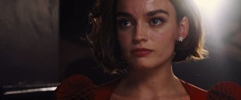 Movie still from “Death on the Nile” (2022), directed by Kenneth Branagh – A person with short curly hair; Close Up shot, Over the shoulder angle