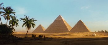 Movie still from “Death on the Nile” (2022), directed by Kenneth Branagh – A group of men riding on the back of a camel; Extreme Wide shot, Low angle