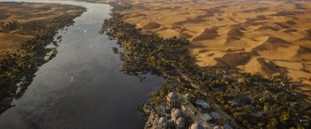 Movie still from “Death on the Nile” (2022), directed by Kenneth Branagh – An aerial view of a large body of water; Extreme Wide shot, High angle
