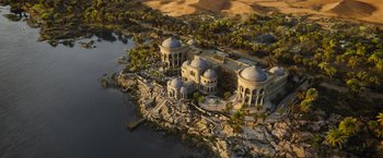 Movie still from “Death on the Nile” (2022), directed by Kenneth Branagh – An aerial view of an island in the middle of the desert; Extreme Wide shot, High angle