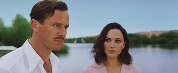 Movie still from “Death on the Nile” (2022), directed by Kenneth Branagh – A man and a woman standing next to a body of water; Close Up shot, Over the shoulder angle