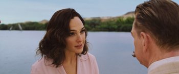 Movie still from “Death on the Nile” (2022), directed by Kenneth Branagh – A person near a body of water; Close Up shot, Over the shoulder angle