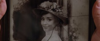 Movie still from “Death on the Nile” (2022), directed by Kenneth Branagh – An old photo of a woman wearing a hat; Extreme Close Up shot, High angle