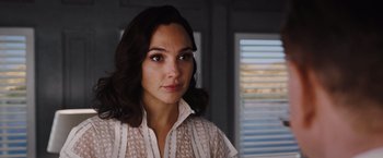 Movie still from “Death on the Nile” (2022), directed by Kenneth Branagh – A person wearing a white shirt; Close Up shot, Over the shoulder angle