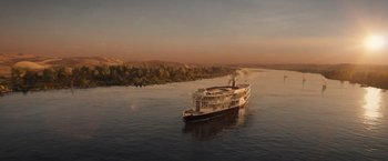 Movie still from “Death on the Nile” (2022), directed by Kenneth Branagh – A large boat floating on top of a body of water; Extreme Wide shot, High angle