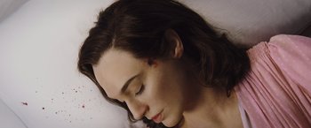 Movie still from “Death on the Nile” (2022), directed by Kenneth Branagh – A woman's face as she lays down; Close Up shot, Overhead angle