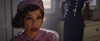 Movie still from “Death on the Nile” (2022), directed by Kenneth Branagh – A person wearing a hat; Close Up shot, Over the shoulder angle