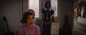 Movie still from “Death on the Nile” (2022), directed by Kenneth Branagh – Two women standing next to each other in front of a window; Medium shot, Over the shoulder angle