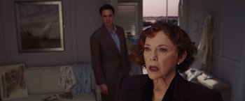 Movie still from “Death on the Nile” (2022), directed by Kenneth Branagh – An older woman and a younger man in a room; Medium shot, Over the shoulder angle