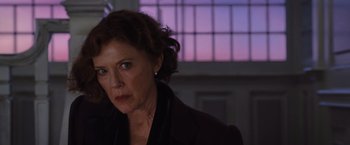 Movie still from “Death on the Nile” (2022), directed by Kenneth Branagh – An older woman in a black jacket looking at the camera; Close Up shot, Low angle