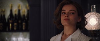 Movie still from “Death on the Nile” (2022), directed by Kenneth Branagh – A person with short hair; Close Up shot, Over the shoulder angle