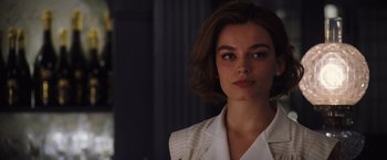 Movie still from “Death on the Nile” (2022), directed by Kenneth Branagh – A person with short hair; Close Up shot, Over the shoulder angle