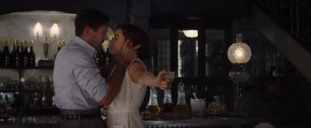 Movie still from “Death on the Nile” (2022), directed by Kenneth Branagh – A man and a woman dancing in front of a bar; Medium shot, Low angle