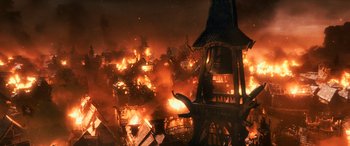 Movie still from “The Hobbit: The Battle of the Five Armies” (2014), directed by Peter Jackson – A fire is burning in the middle of the night; Extreme Wide shot, High angle
