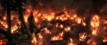 Movie still from “The Hobbit: The Battle of the Five Armies” (2014), directed by Peter Jackson – A fire is burning in the middle of the night; Extreme Wide shot, High angle