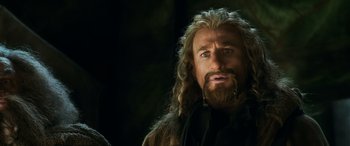 Movie still from “The Hobbit: The Battle of the Five Armies” (2014), directed by Peter Jackson – A person with long hair and a beard; Close Up shot, Low angle
